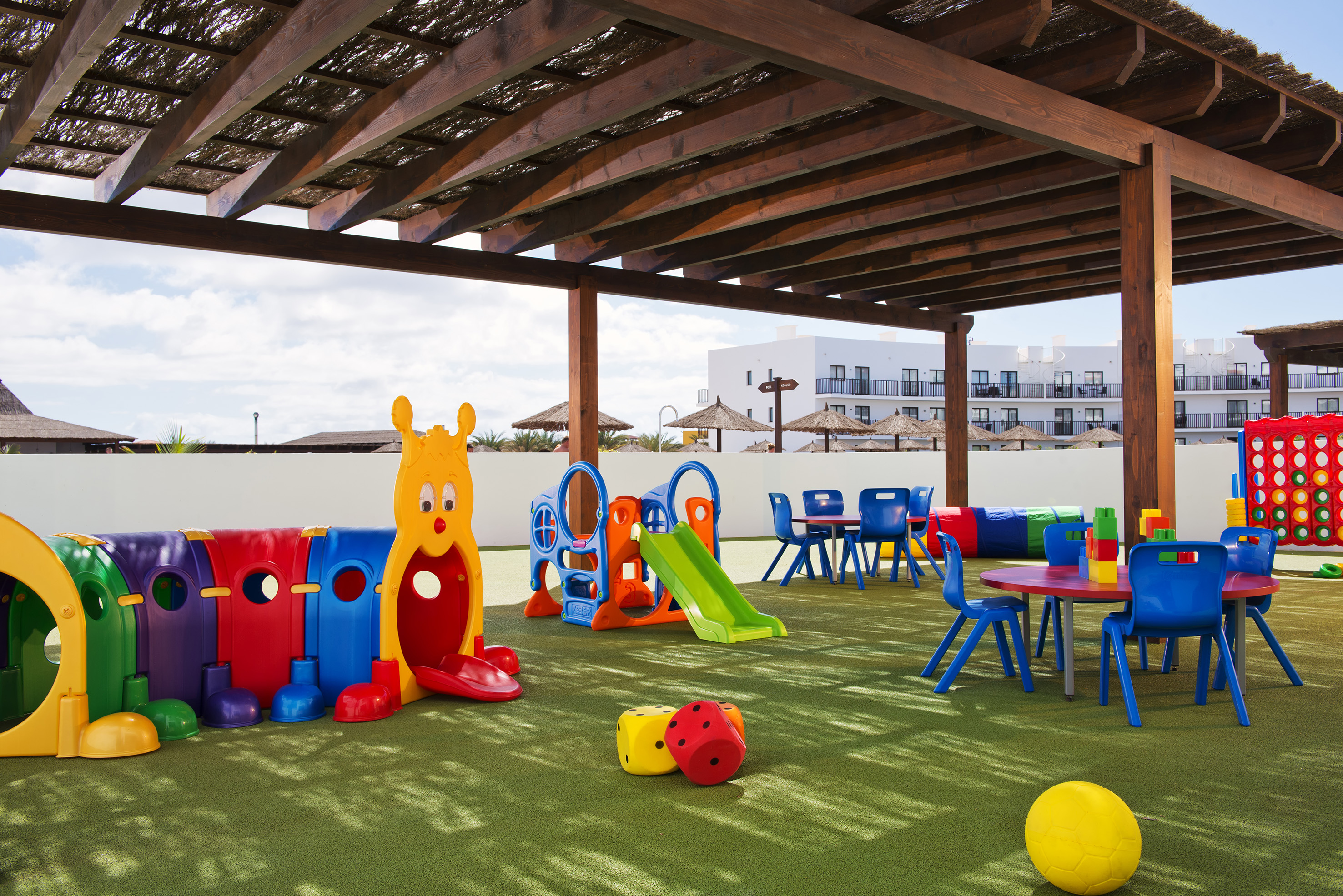 a playground with colorful toys and tables