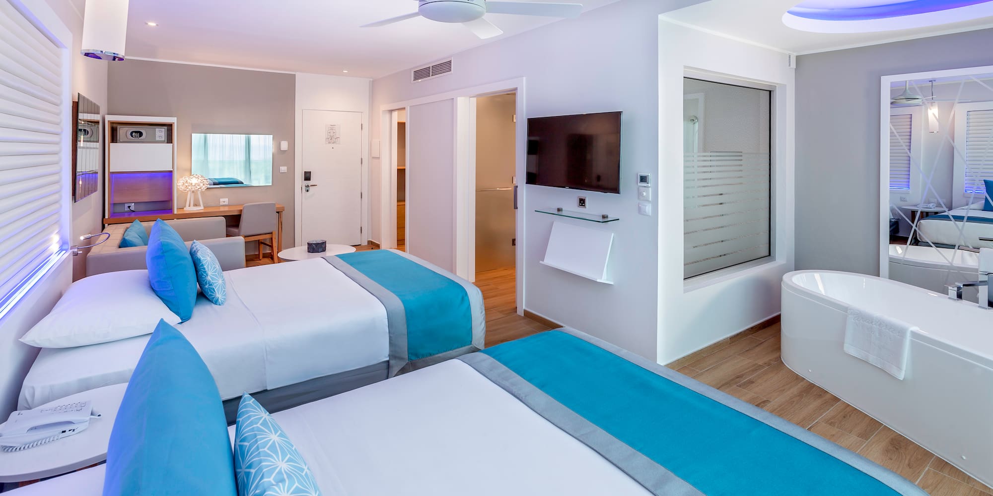 a room with two beds and a tub