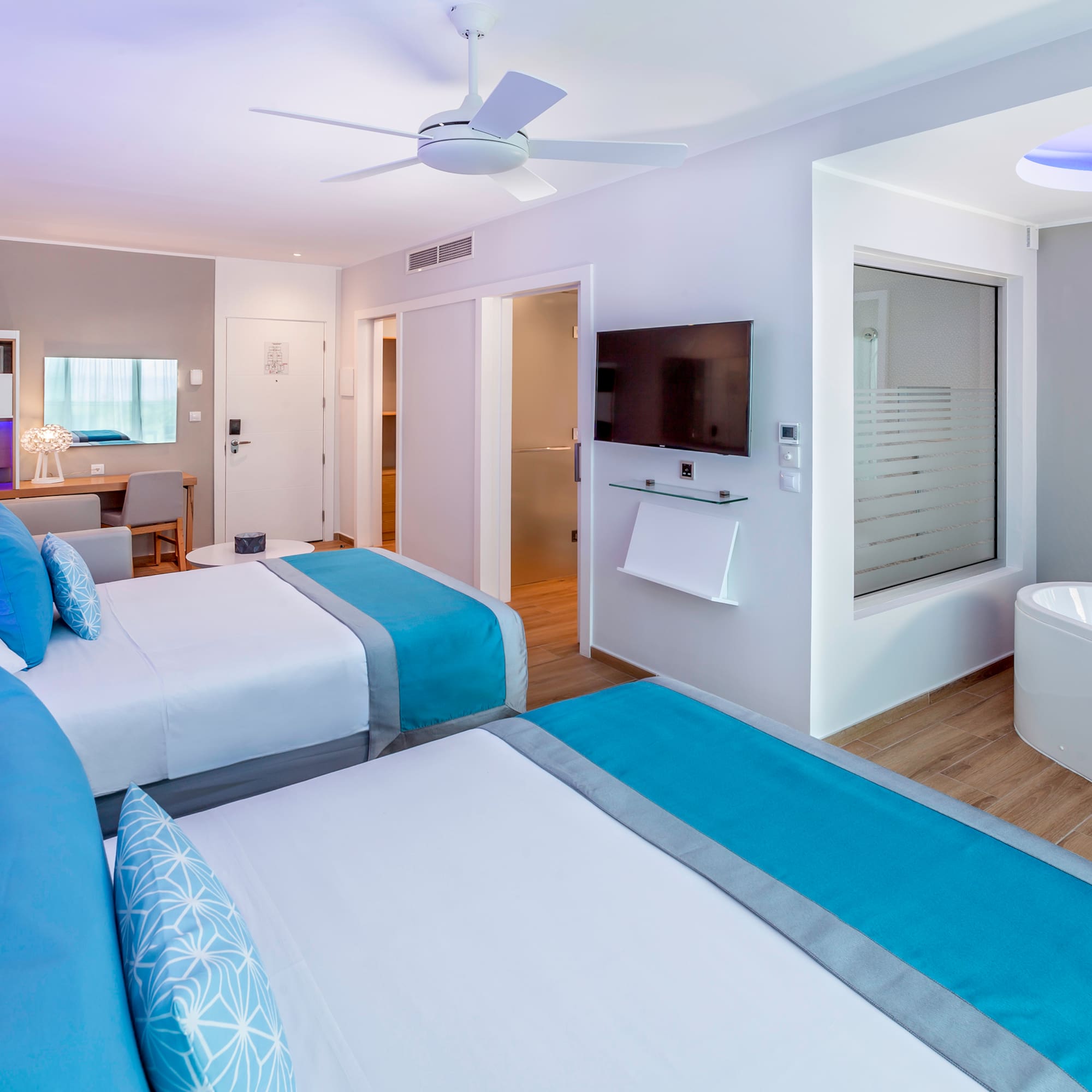 a room with two beds and a tub