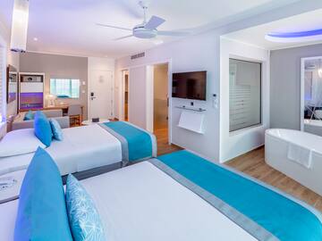 a room with two beds and a tub