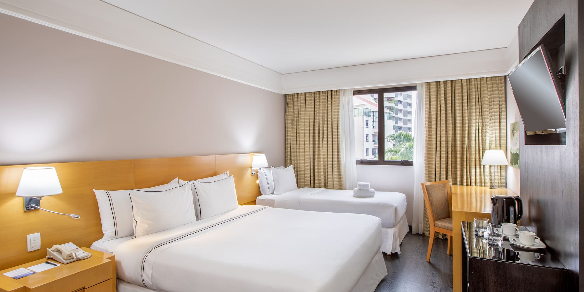 a room with two beds and a desk