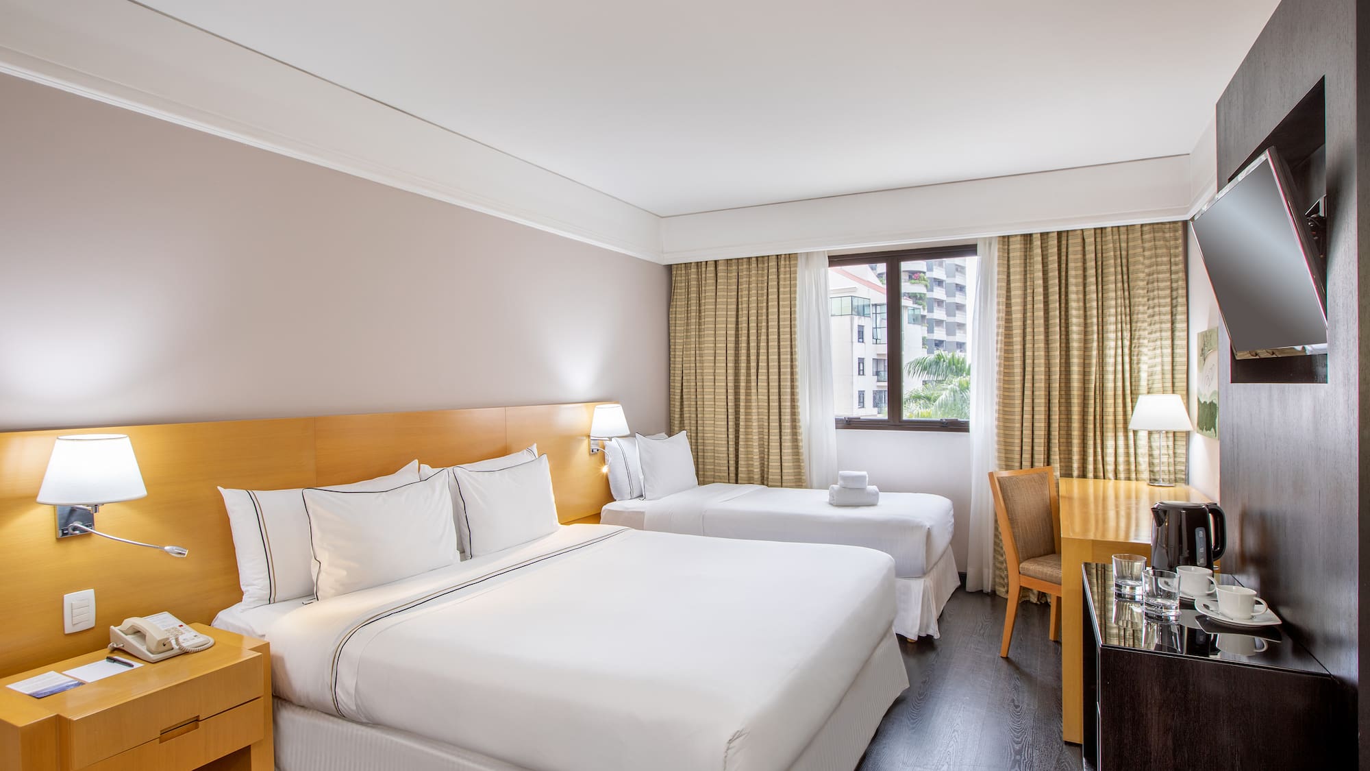 a room with two beds and a desk