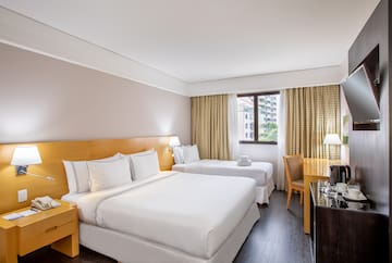 a room with two beds and a desk