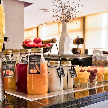 a group of glass jars of fruit and juice