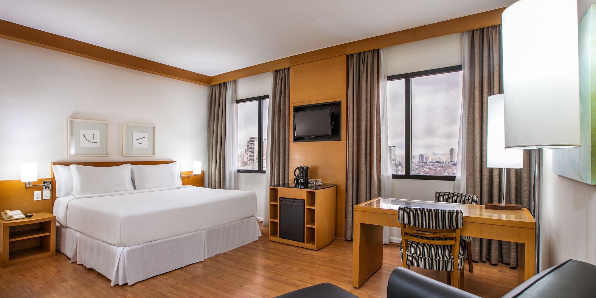 a room with a bed and a desk and chair