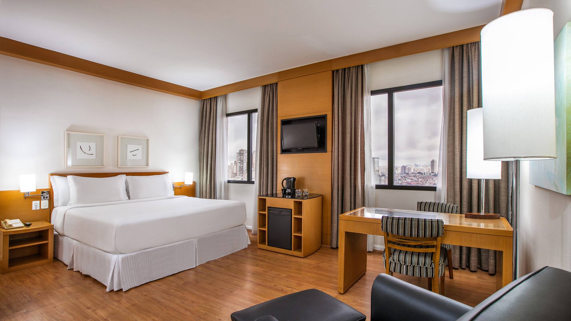 a room with a bed and a desk and chair