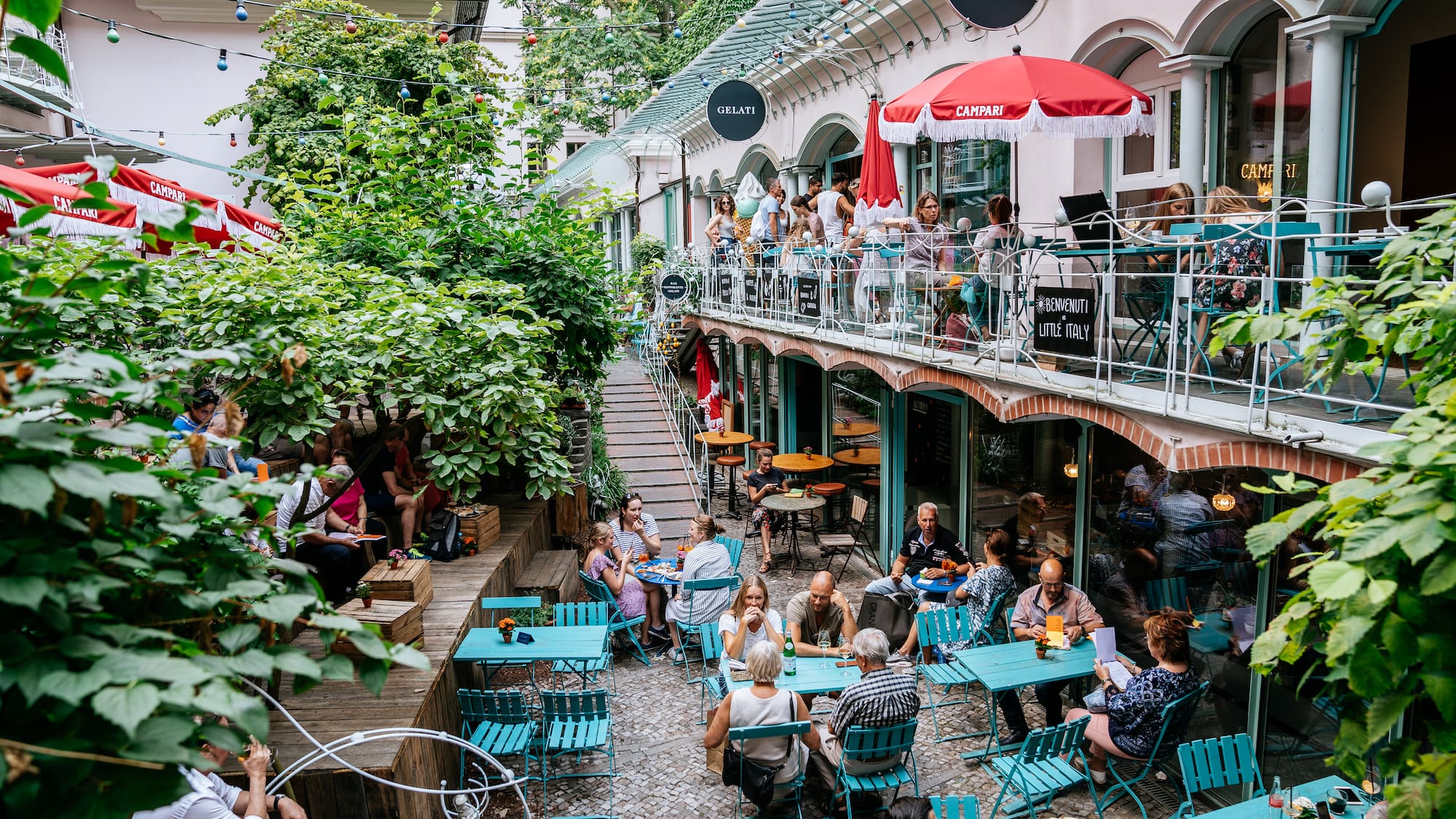 a group of people sitting at tables outside a building