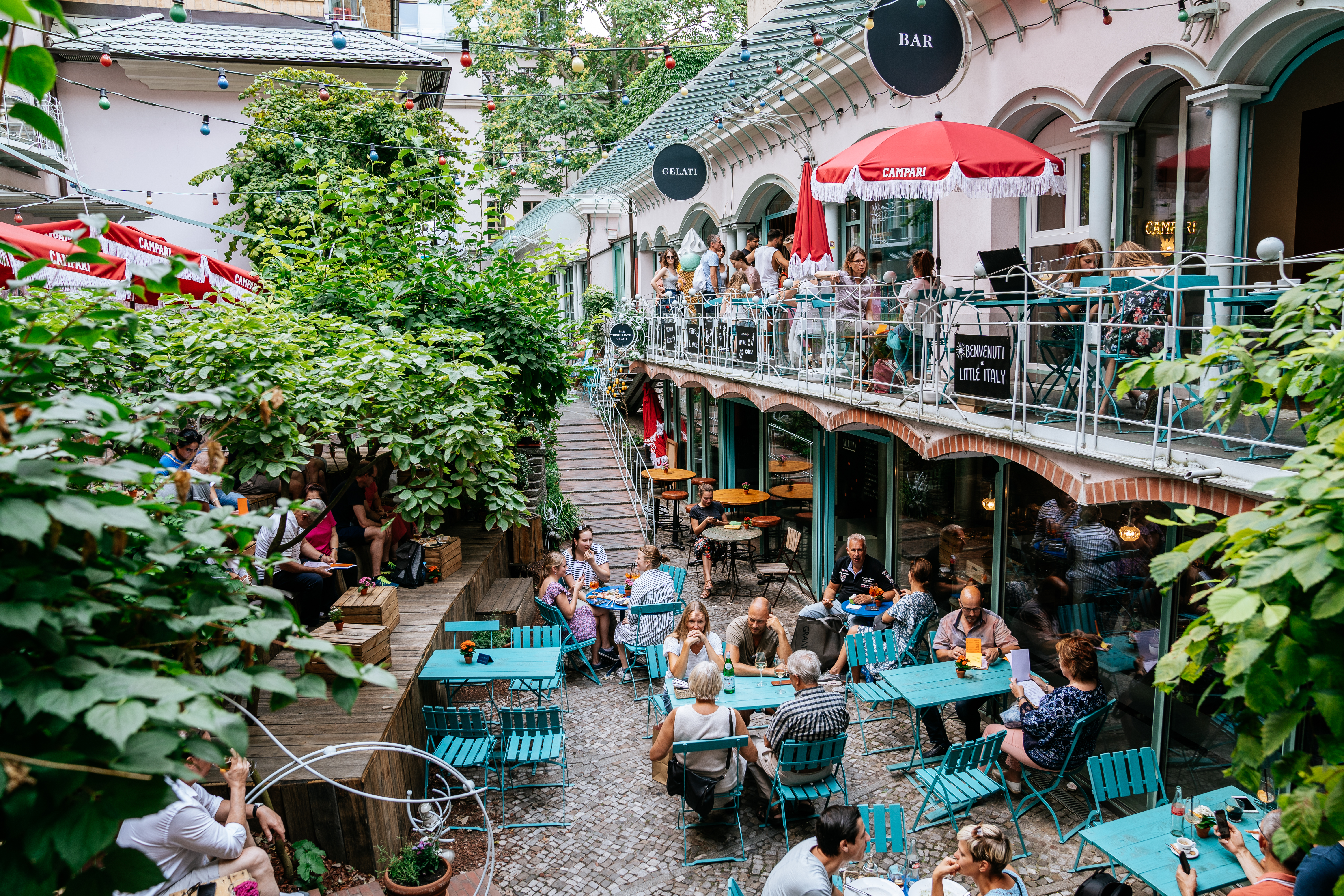 a group of people sitting at tables outside a building