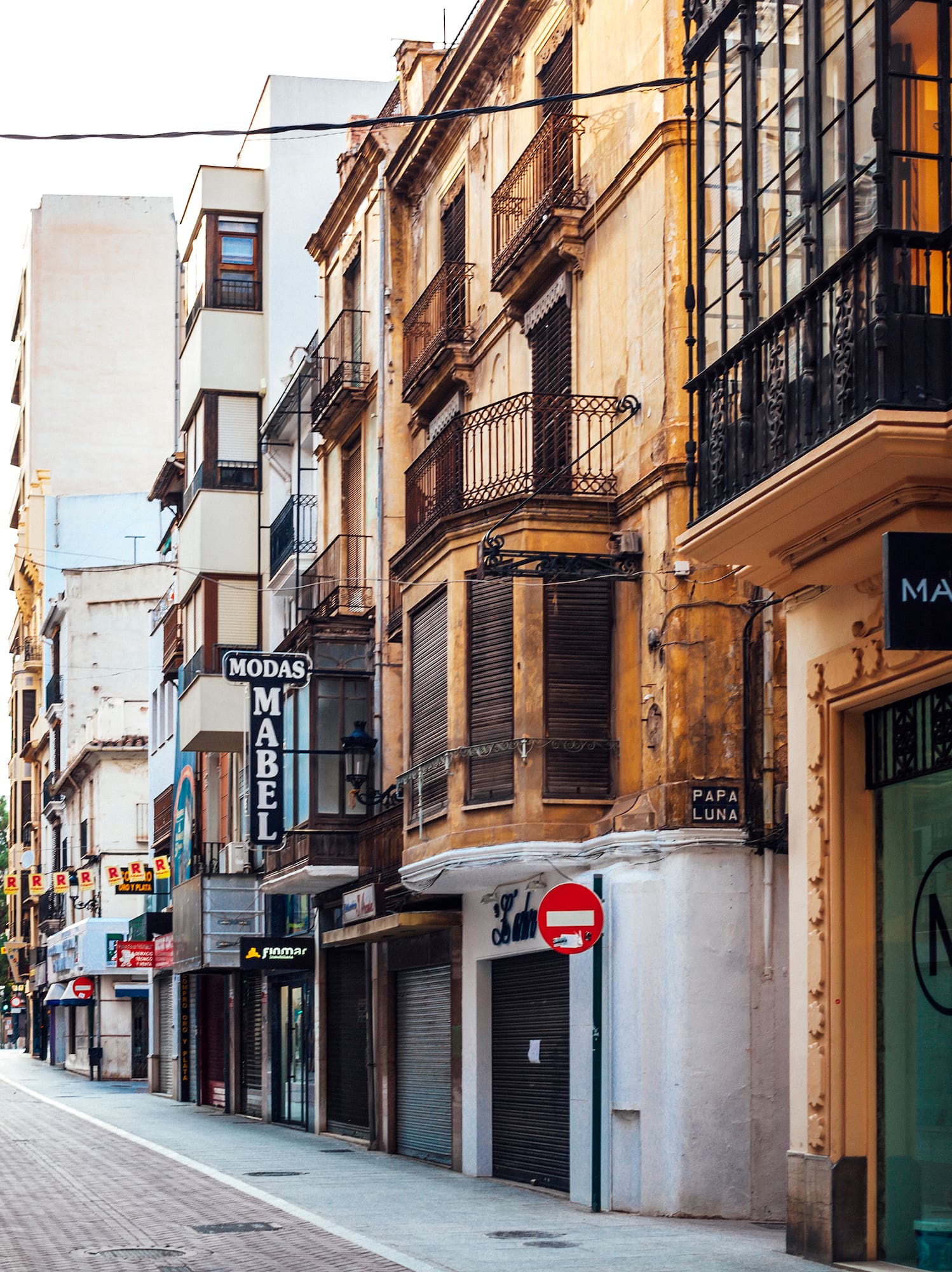a street with buildings and people walking on it