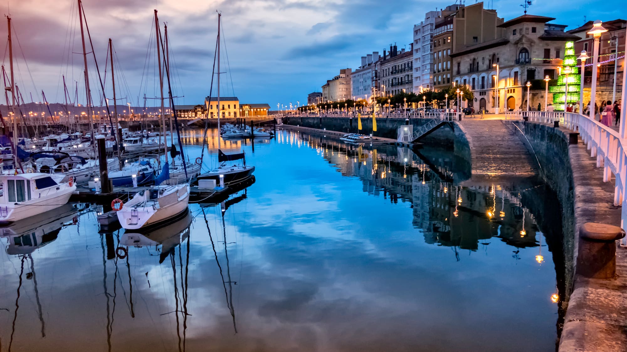 a body of water with boats and buildings in the background