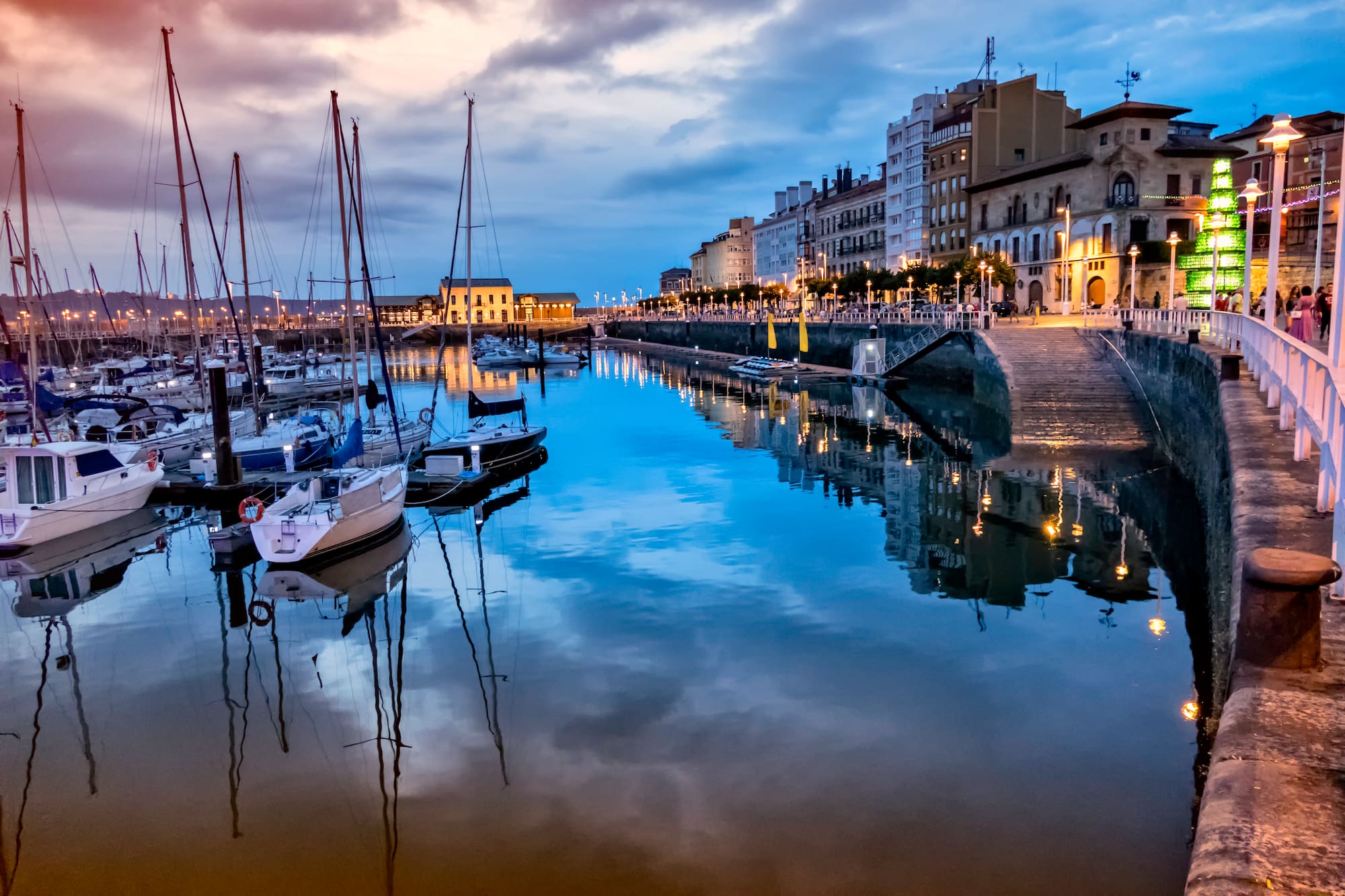 a body of water with boats and buildings in the background