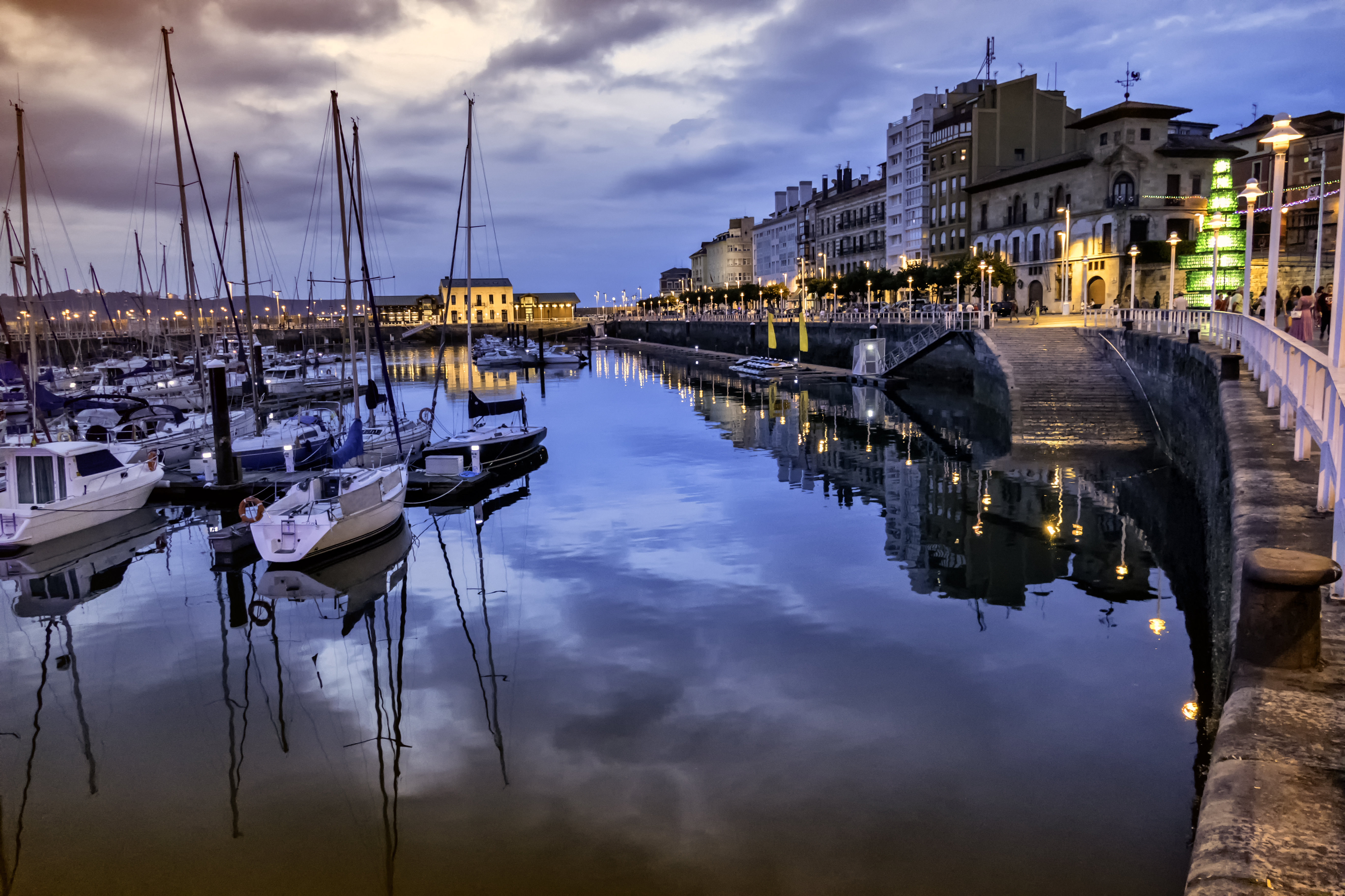 a body of water with boats and buildings in the background