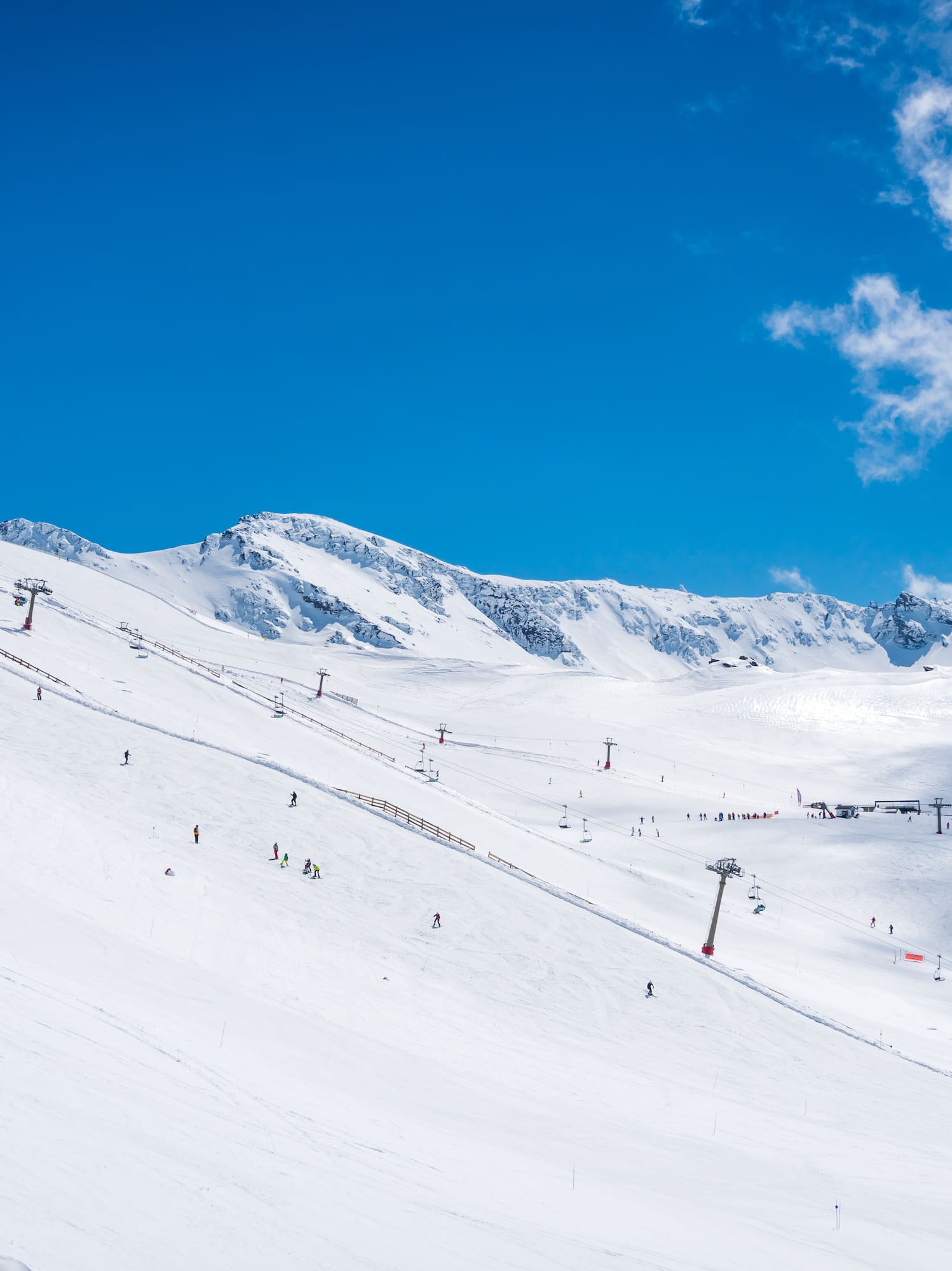 a snow covered mountain with people skiing