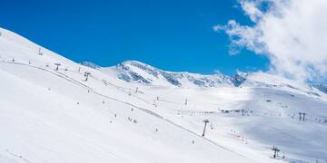 a snow covered mountain with people skiing