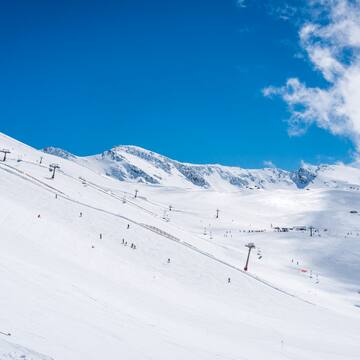 a snow covered mountain with people skiing
