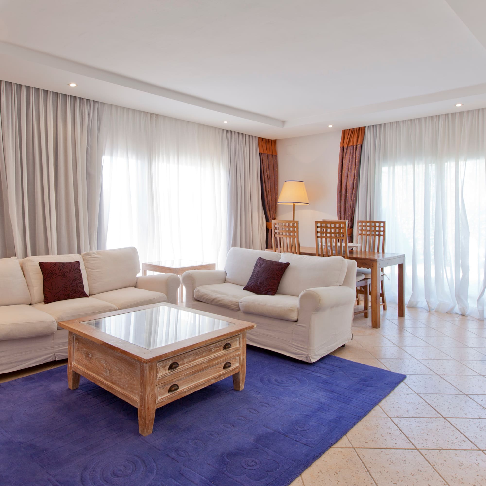 a living room with white couches and a table