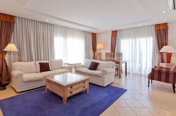 a living room with white couches and a table