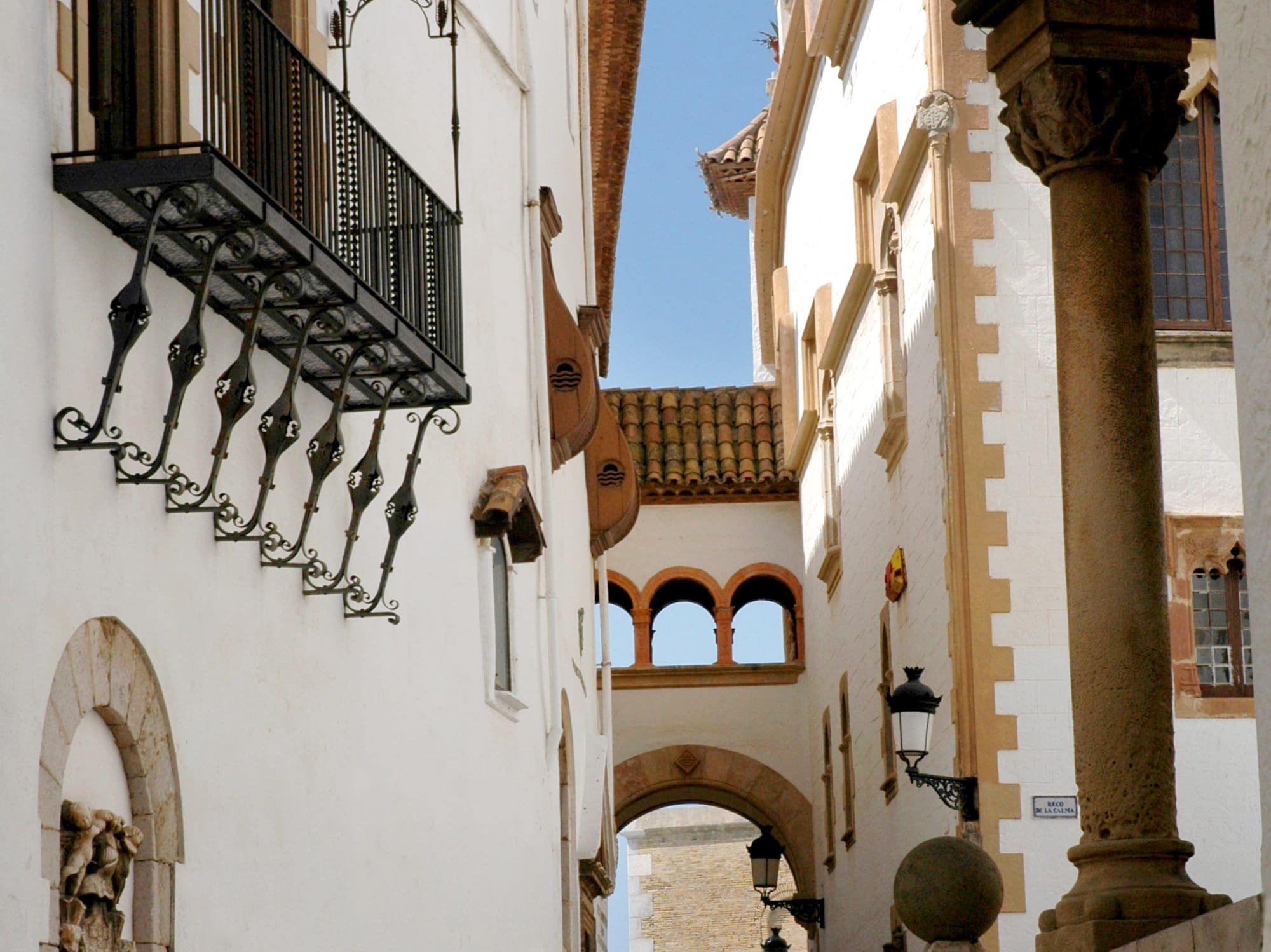 a group of people walking down a narrow street