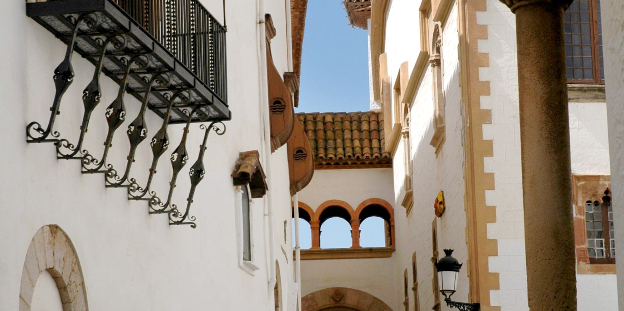 a group of people walking down a narrow street