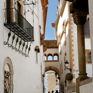 a group of people walking down a narrow street