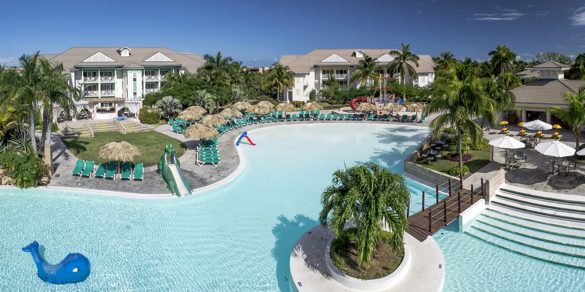 a swimming pool with a slide and palm trees