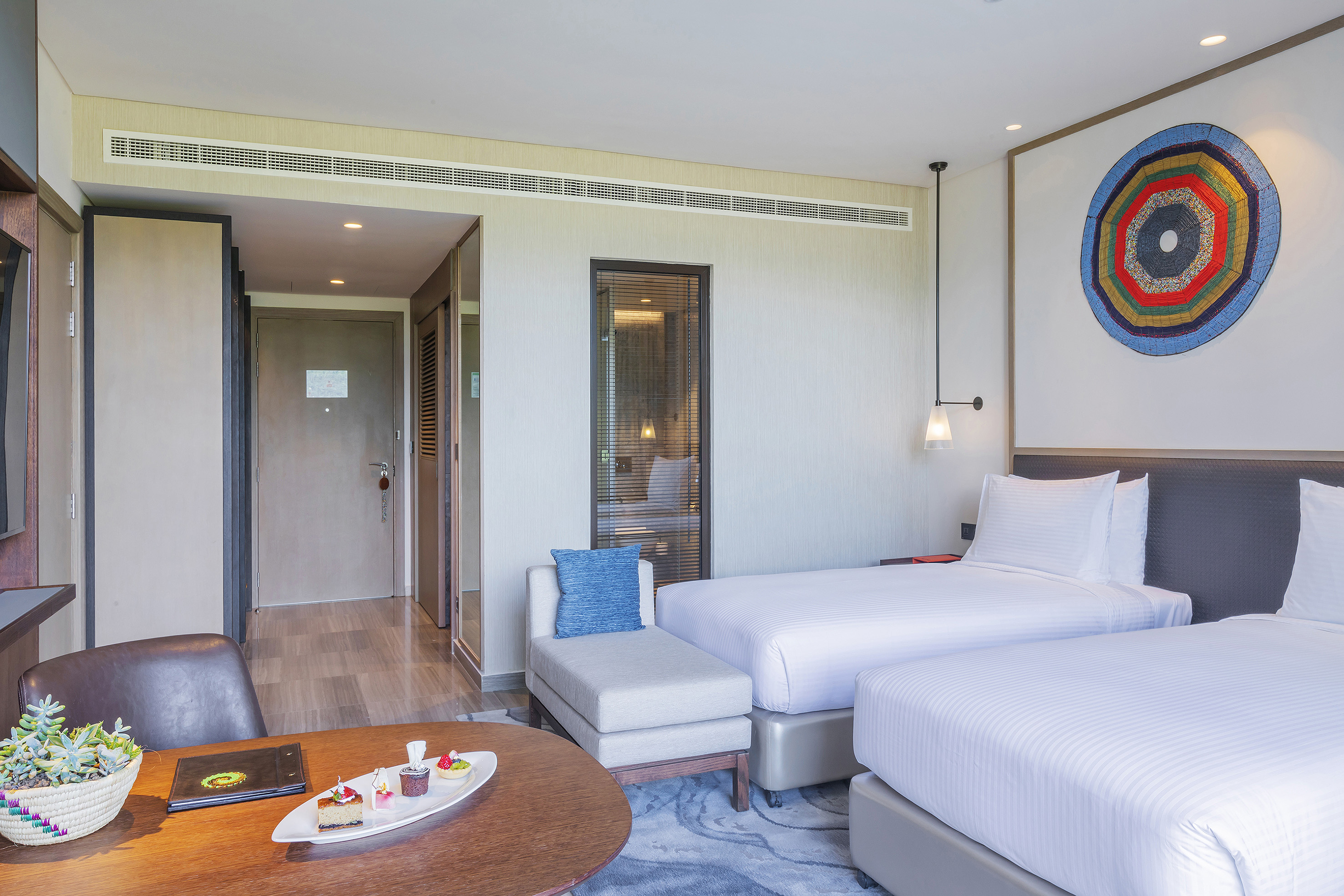 a room with two beds and a table