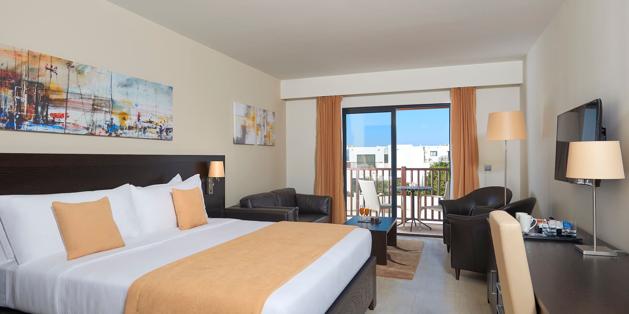 a room with a bed and chairs