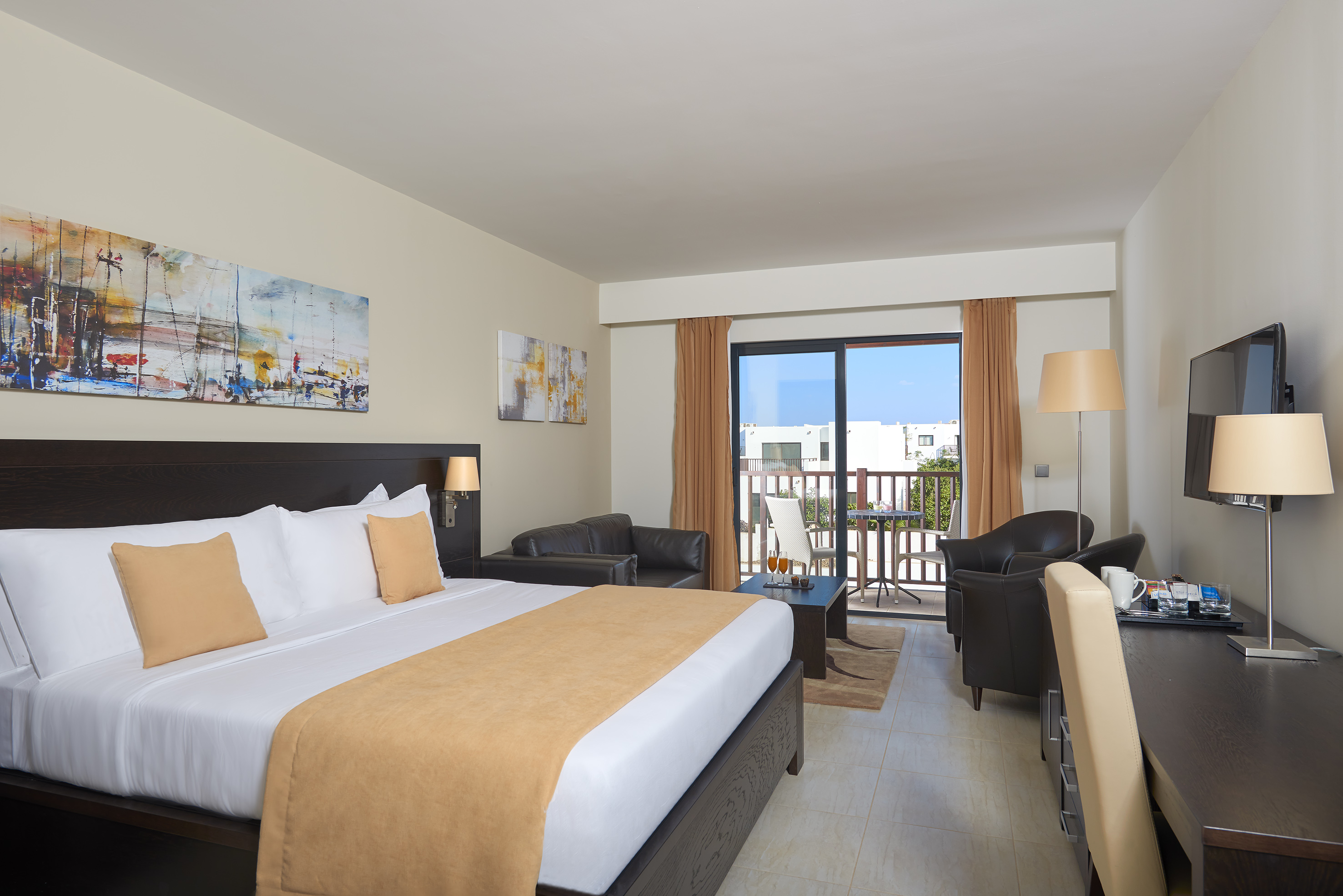 a room with a bed and chairs