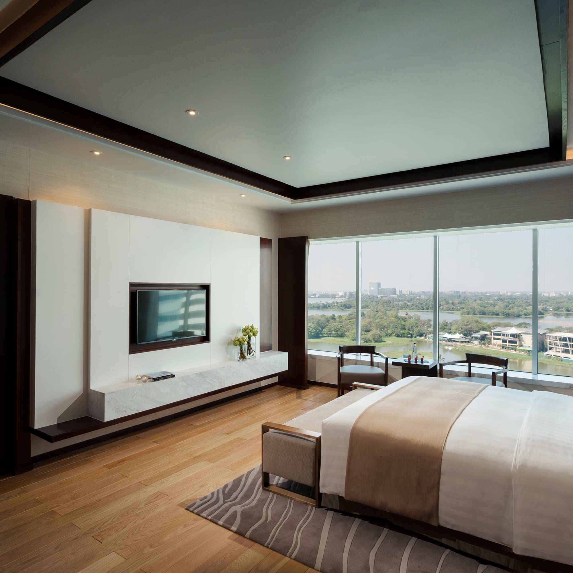 a bedroom with a television and a view of the city