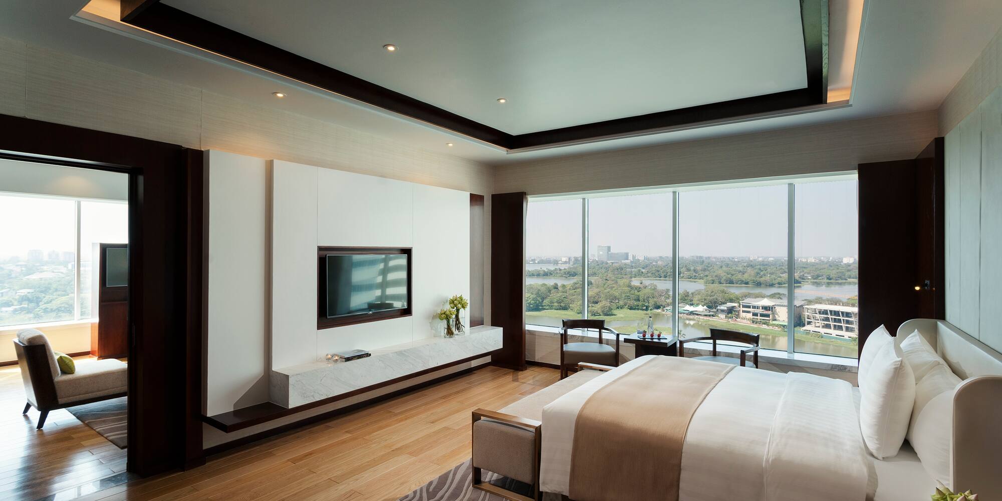 a bedroom with a television and a view of the city