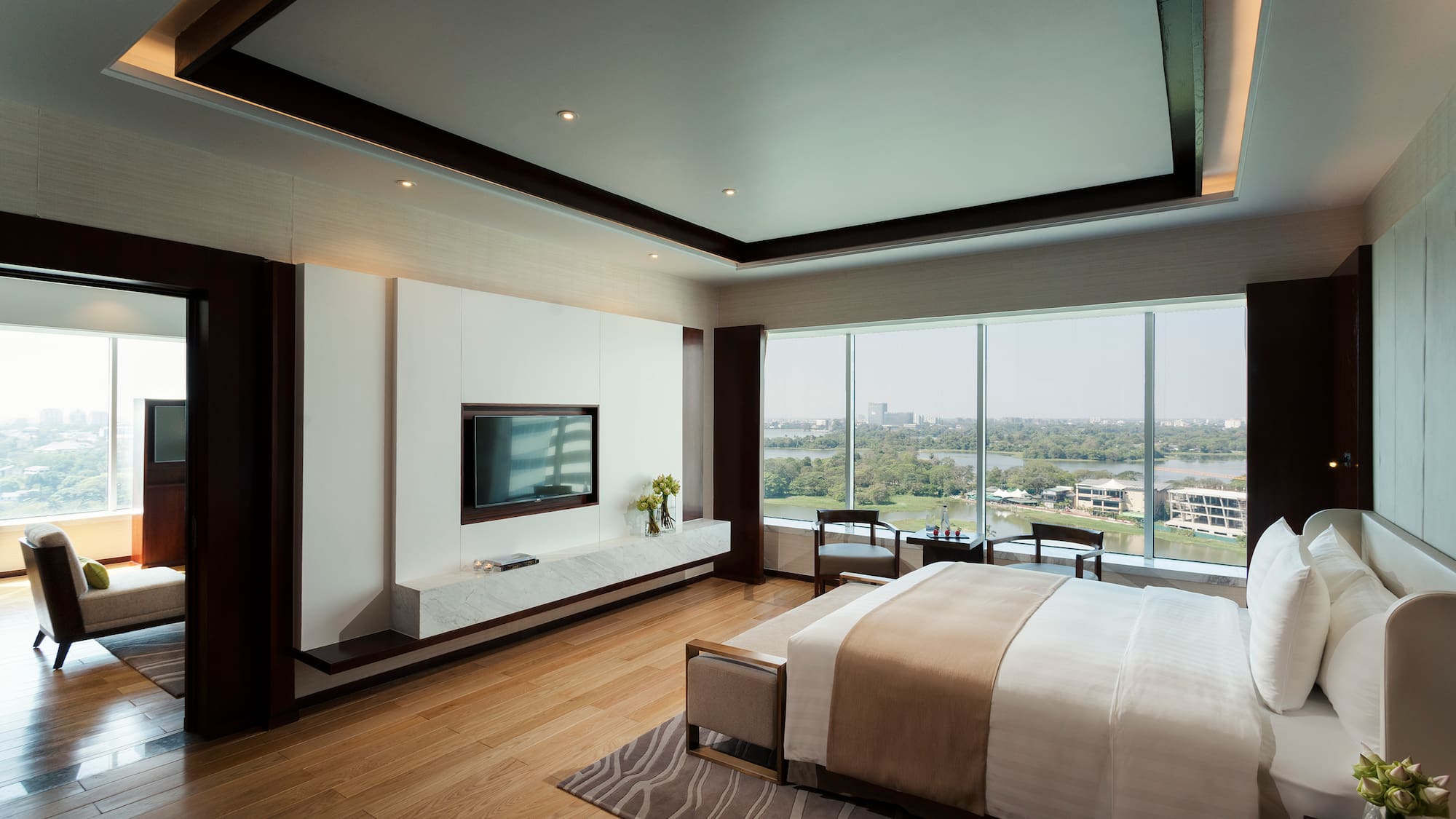 a bedroom with a television and a view of the city