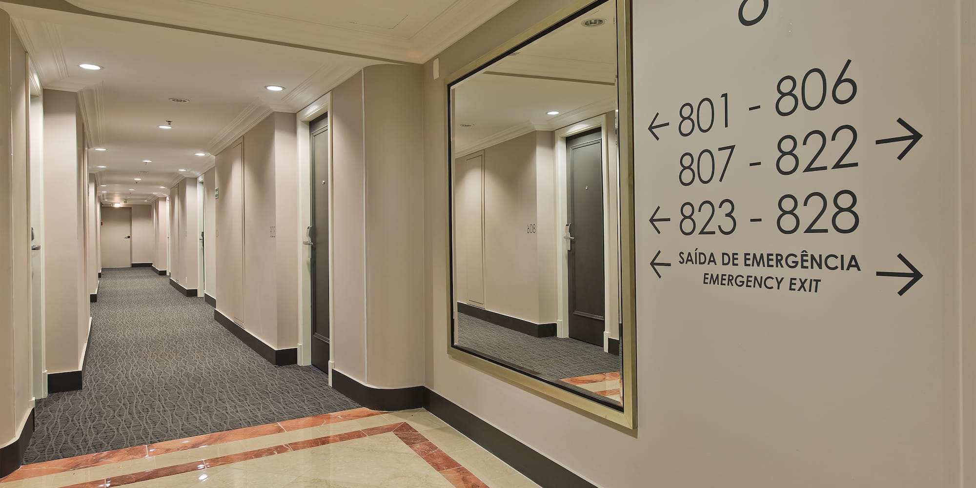 a hallway with a mirror and a door