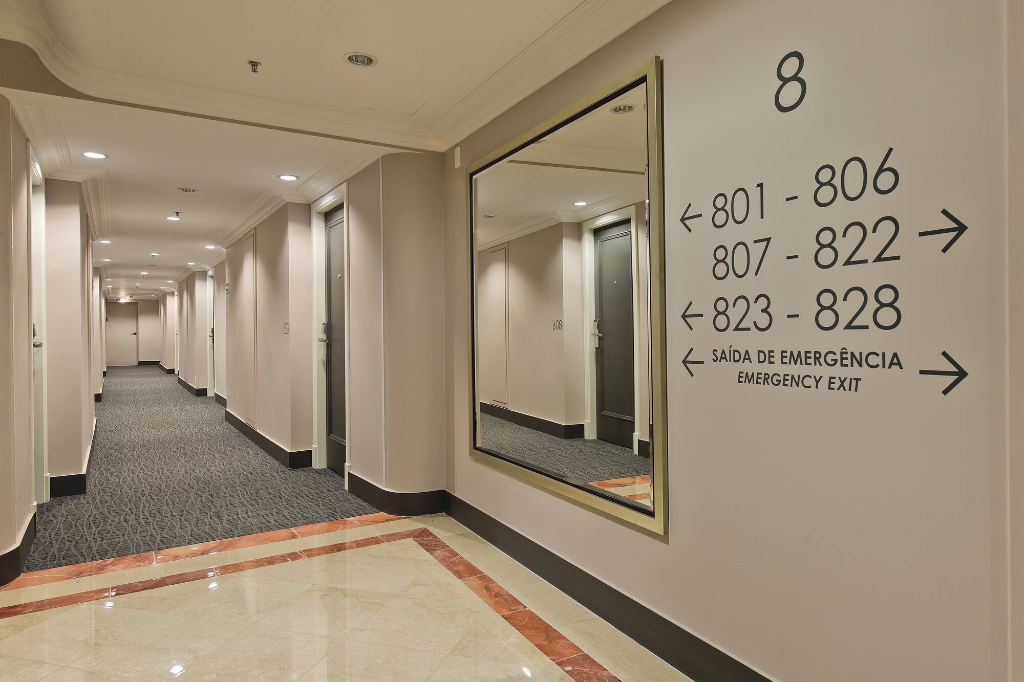 a hallway with a mirror and a door