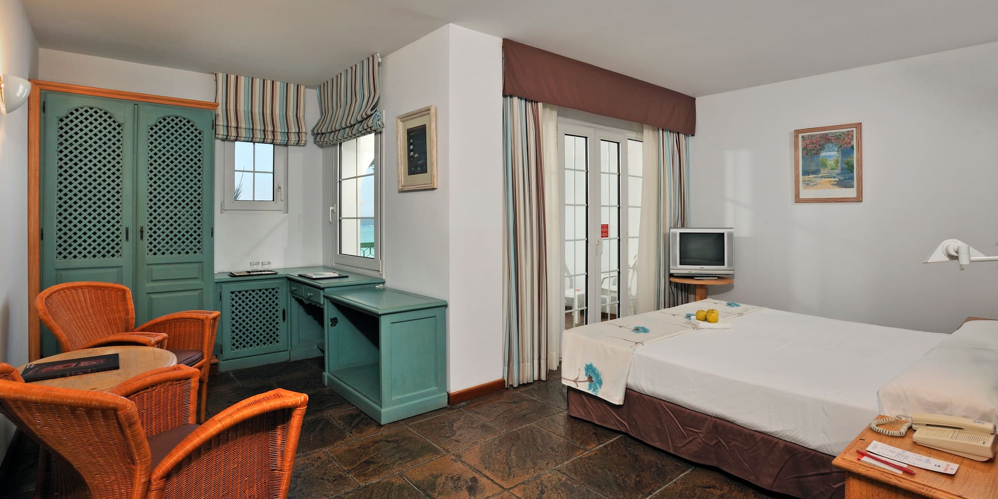 a room with a bed and a television