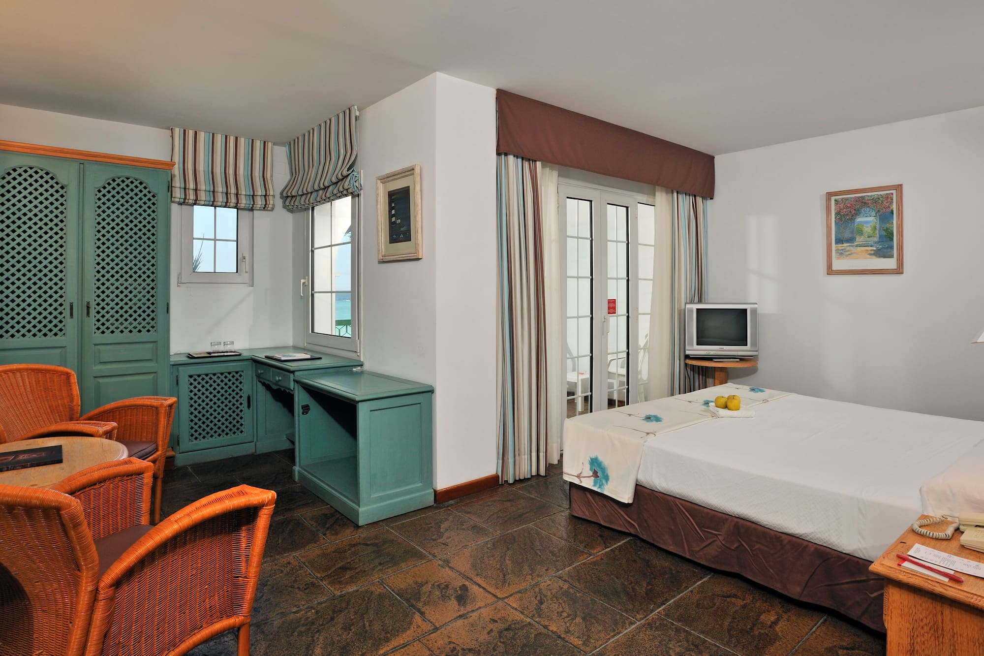 a room with a bed and a television