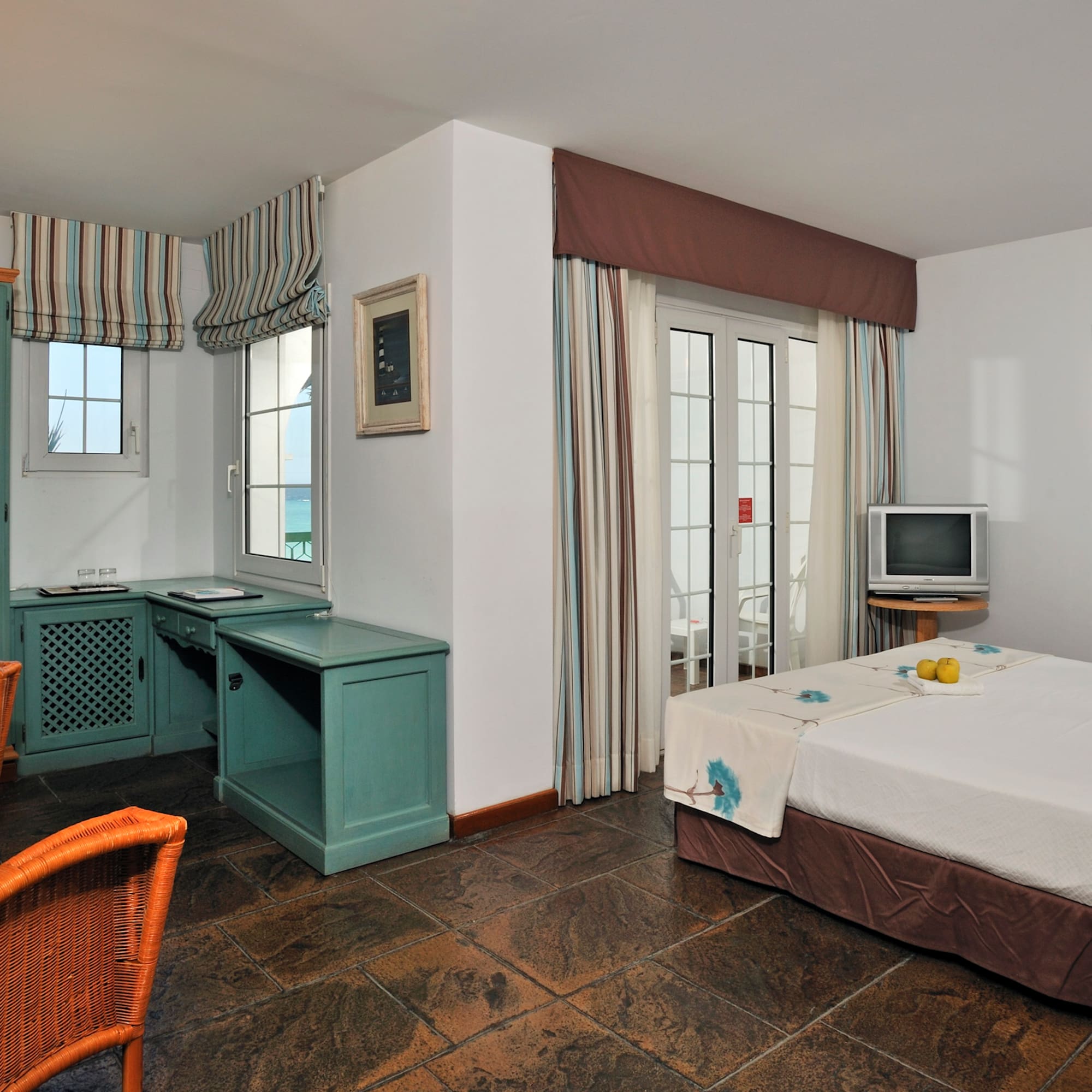 a room with a bed and a television