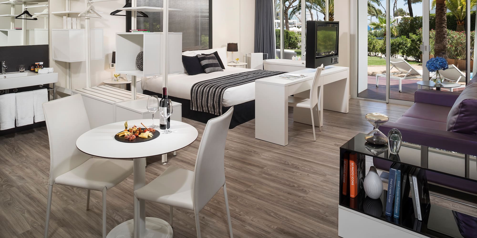 a room with a bed and a table and chairs