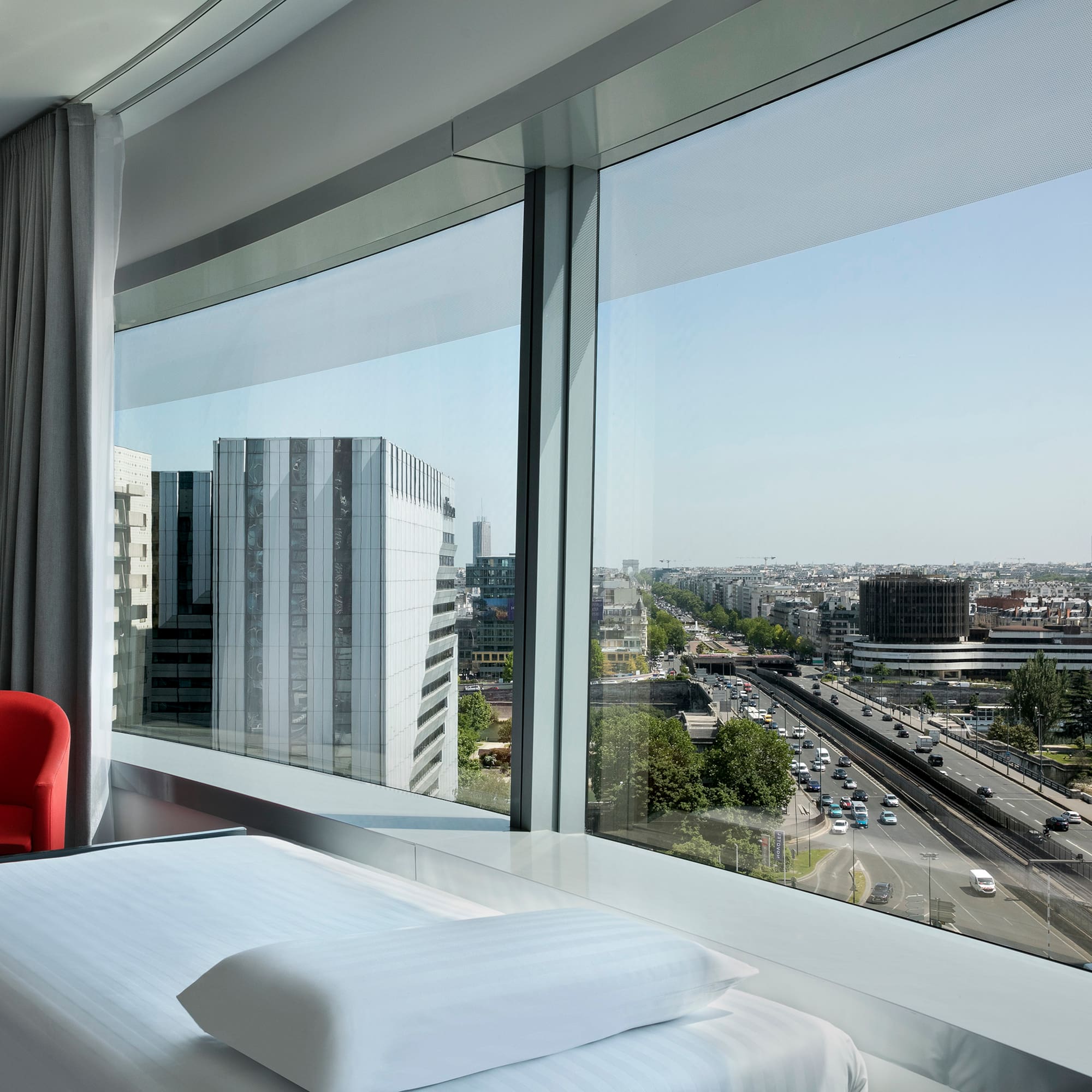 a room with a large window overlooking a city