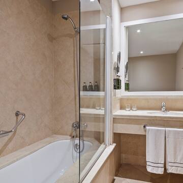 a bathroom with a glass shower door and a bathtub