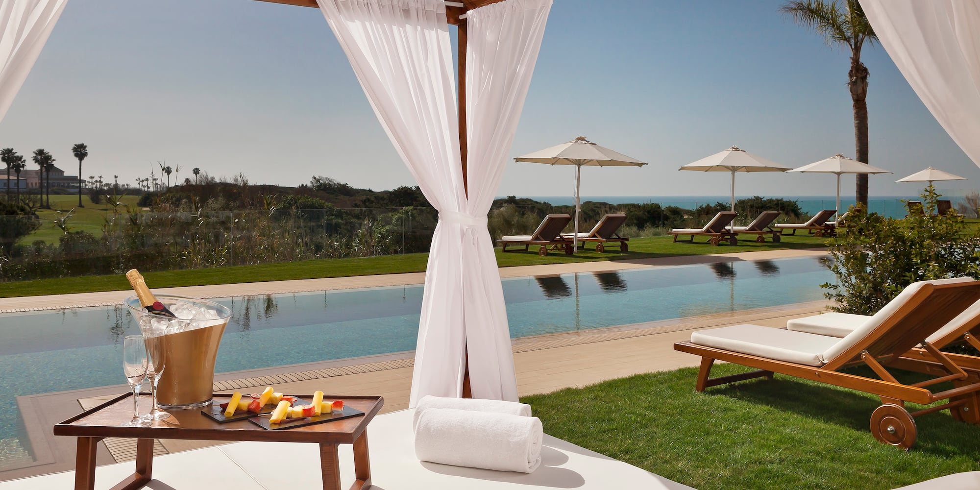 a pool with a lounge chair and a tray of food