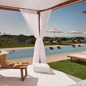 a pool with a lounge chair and a tray of food