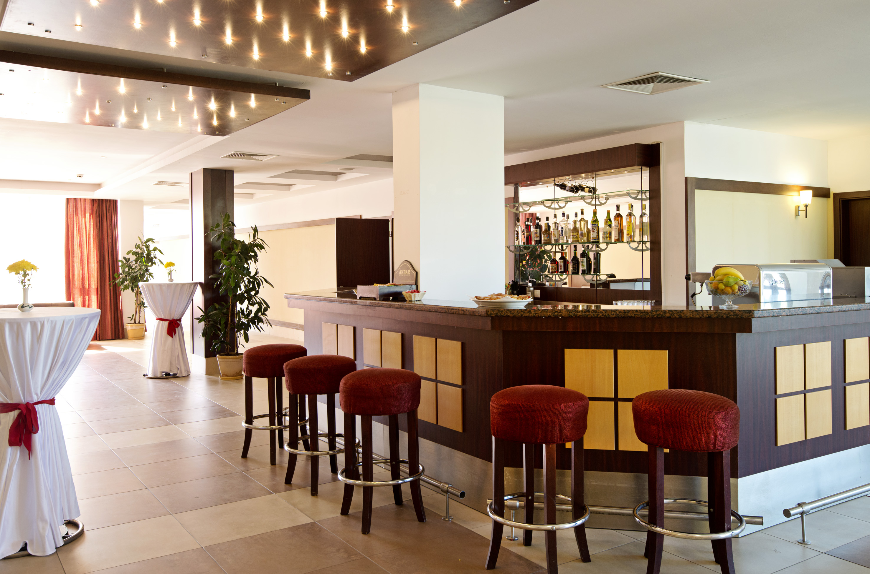 a bar with stools in a room