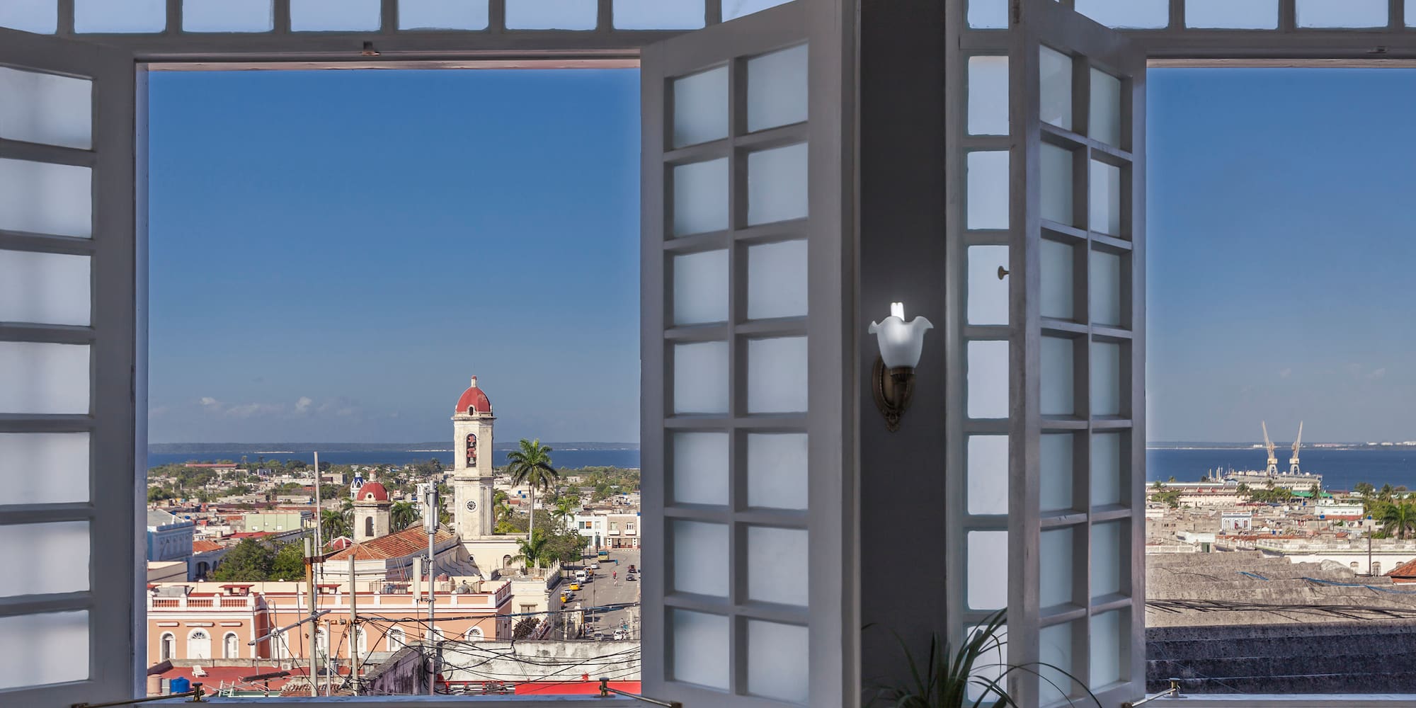 a window with a view of a city and a building