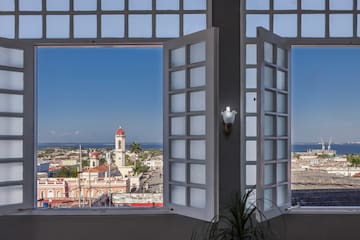 a window with a view of a city and a building