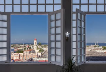 a window with a view of a city and a building