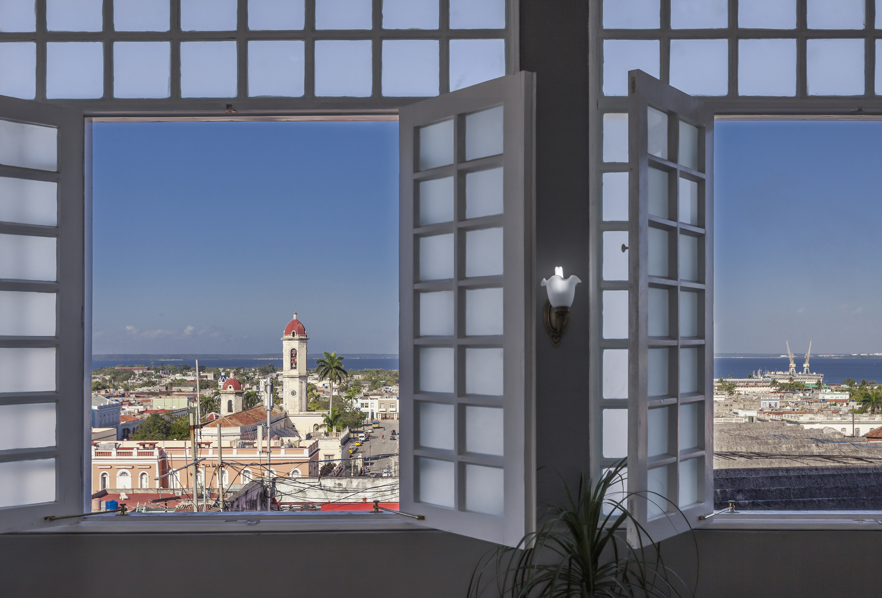 a window with a view of a city and a building