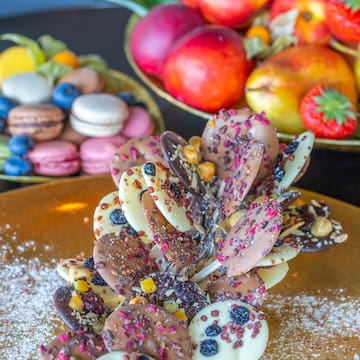 a plate of food with fruit and macaroons
