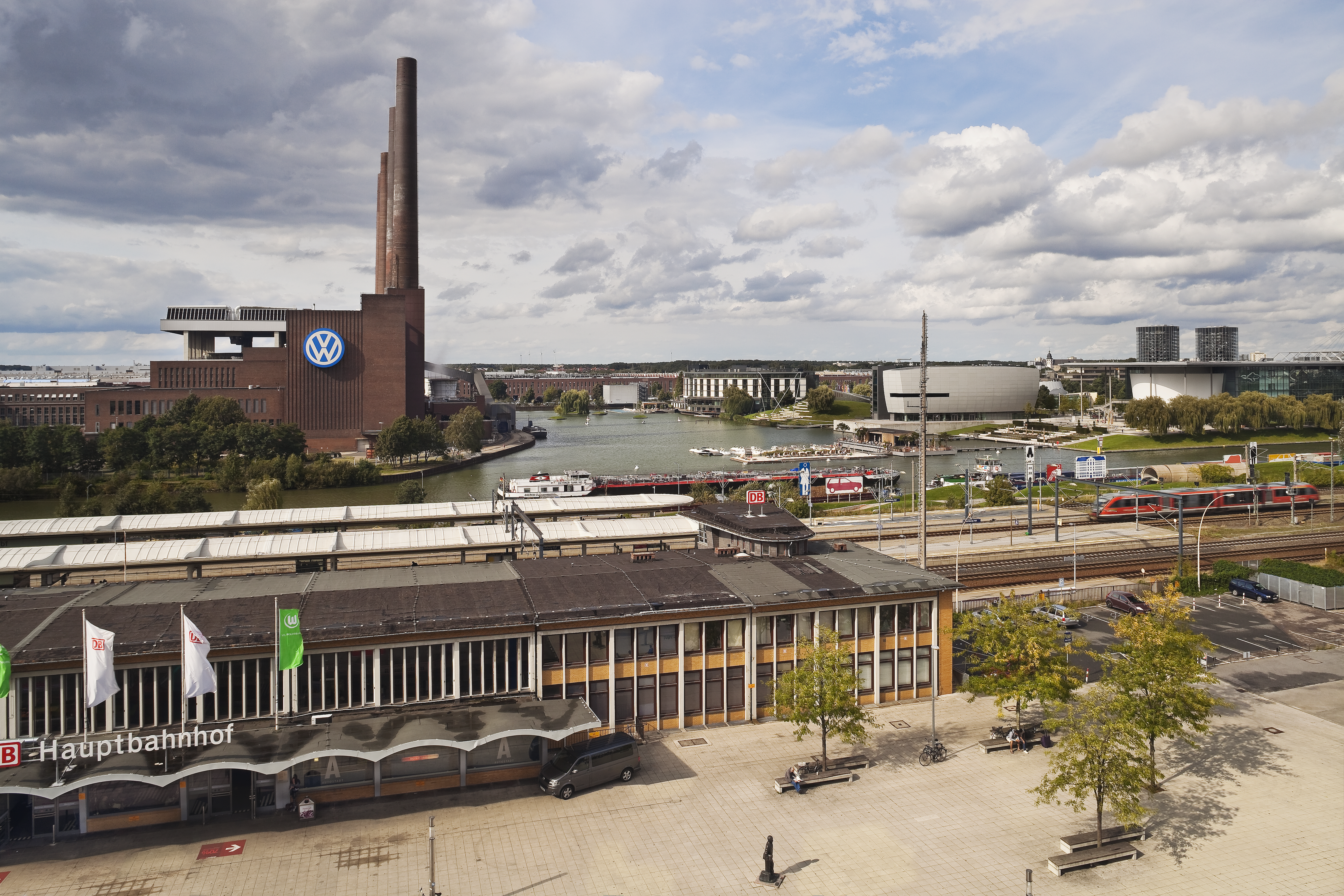 Wolfsburg Autostadt with VW factory, canal, and Hauptbahnhof train station.