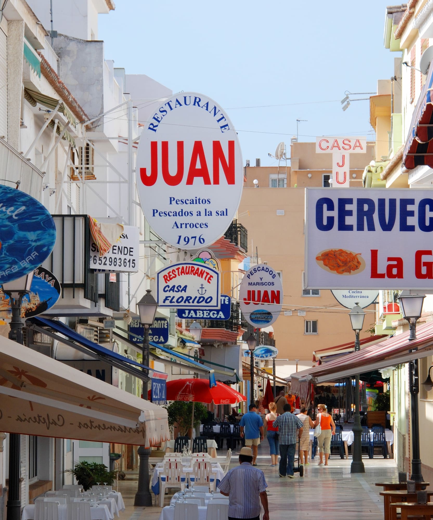 a street with signs and people walking