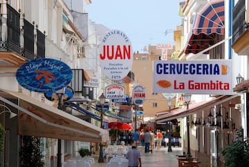 a street with signs and people walking